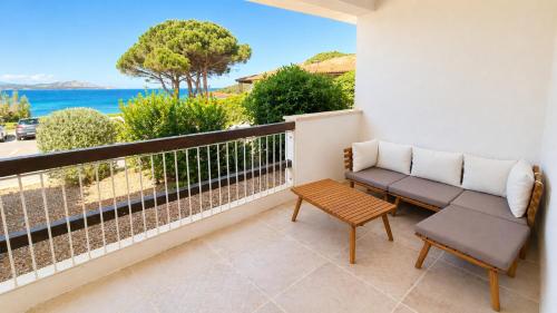 a balcony with a bench and a view of the ocean at Rena Bianca Residence 201 in Baja Sardinia