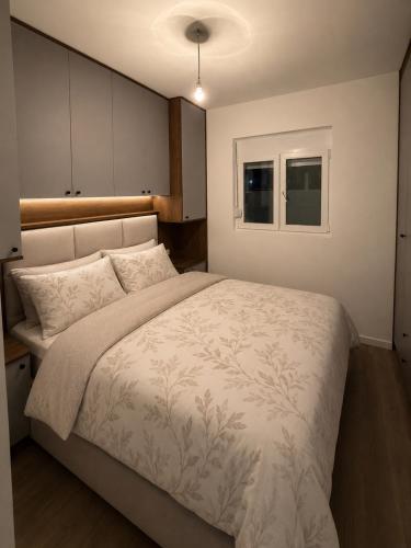 a bedroom with a large bed and a window at Cozy aparment Susanj,Bar in Bar
