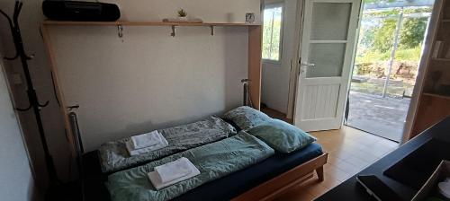 a bedroom with a bed with two pillows on it at Olive Gardens Cottage above Portorož in Strunjan