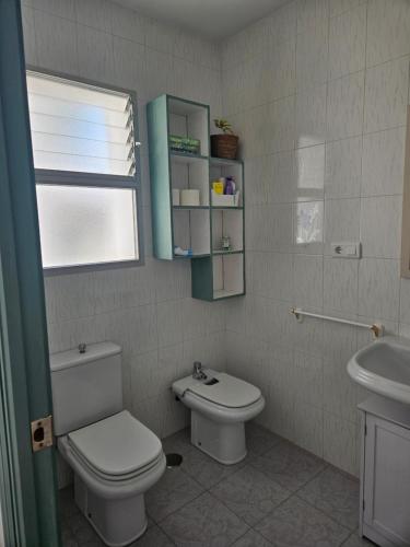 a bathroom with a toilet and a sink at La Bohème in Antequera