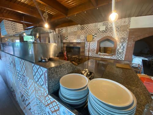 a kitchen with a bunch of plates on a counter at Masseria della Fontana Vecchia in San Cipriano Picentino