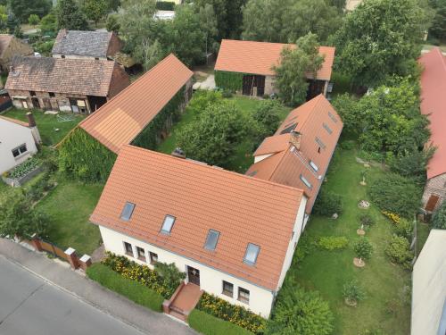 an overhead view of a house with an orange roof at Ferienhaus Pathe in Neuendorf bei Wendisch Buchholz
