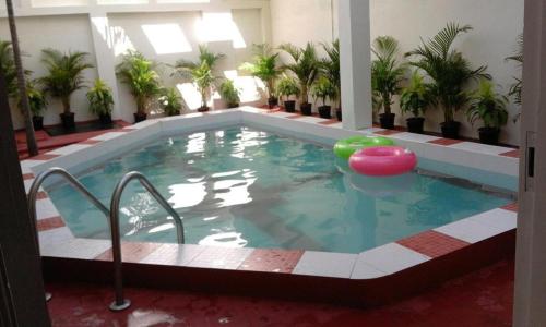 a pool in a building with a swimming pool at Green Haven Villas in Chennai
