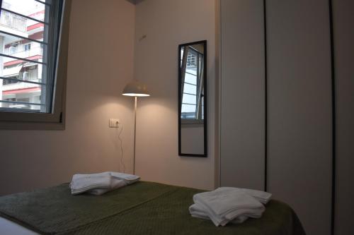 a bedroom with a bed with two white towels on it at Lavandula in Xanthi
