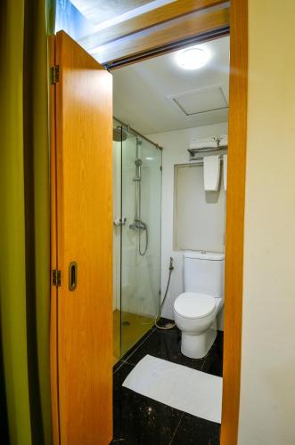 a bathroom with a toilet and a glass shower at Viva Hotel Songkhla in Songkhla