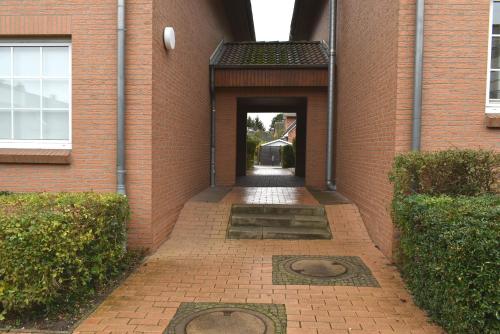 a brick building with a hallway leading to a doorway at Sonnenseite Ferienwohnung in Niendorf