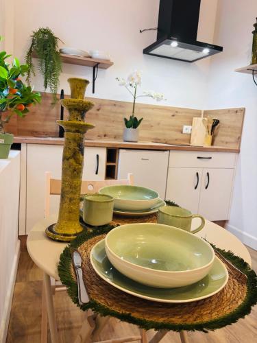 a table with plates and bowls on it in a kitchen at Raíces de Canillas Holiday Apartments in Canillas de Aceituno