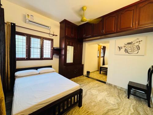 a bedroom with a bed and a desk in it at Fort Grande ONE in Cochin