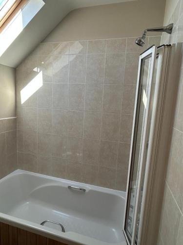 a bathroom with a bath tub with a shower at Fanore Apartment 1 in Fanore