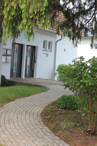 a brick walkway in front of a building at FeWo Atlanta in Reinhardshausen