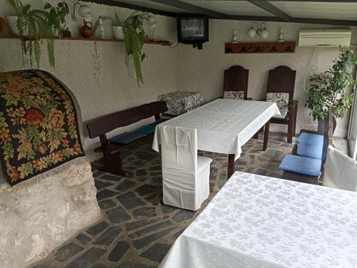 a dining room with two tables and chairs at Villa Savovi in Varna City