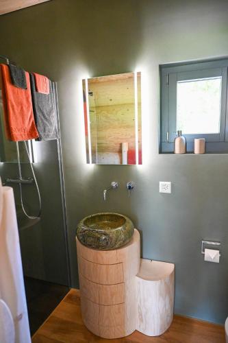 a bathroom with a barrel sink and a shower at Mein Refugium Relax Tiny Haus in Unteriberg