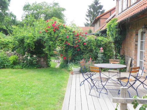 a patio with a table and chairs in a yard at Ferienwohnung Stolz G in Ulrichshusen