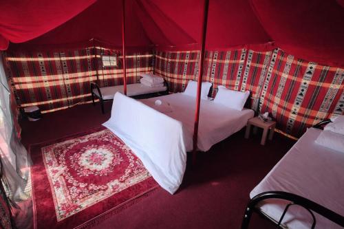 an aerial view of a red tent with two beds at Ocean Camp in Al Qārin