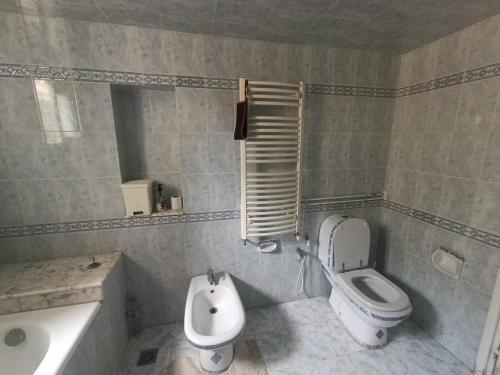 a bathroom with a toilet and a bidet and a sink at Cozy house in Nabeul