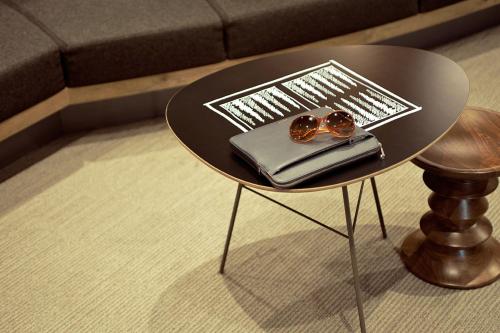 a black table with sunglasses and a book on it at Hotel ibis Lisboa Liberdade in Lisbon