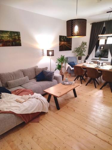 a living room with a couch and a table at FeRo´s Ferienwohnung in Wernigerode