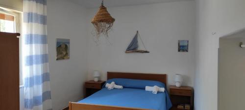 a bedroom with a blue bed with two night stands at Case Vacanze Tropea La Pinnata in Tropea