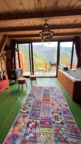 a large rug on the floor in a room with a view at Northland Bungalows in Çayırdüzü