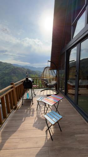 a balcony with a helicopter and chairs on a building at Northland Bungalows in Çayırdüzü