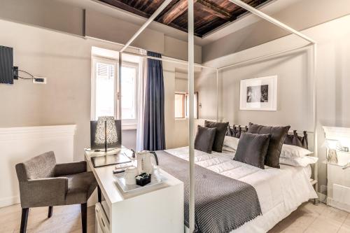 a bedroom with a bed and a desk and a chair at Hotel Clitunno in Spoleto