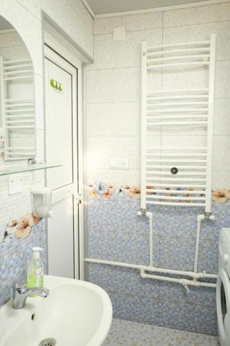 a bathroom with a sink and a shower at apartament dato in Batumi