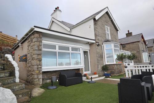a house with a lawn in front of it at Sea View Guest House in Benllech