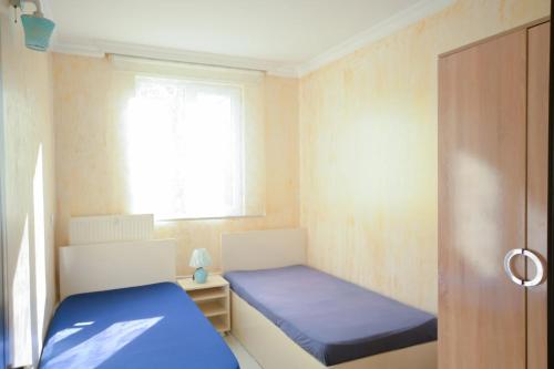 a small room with a bed and a window at apartament dato in Batumi