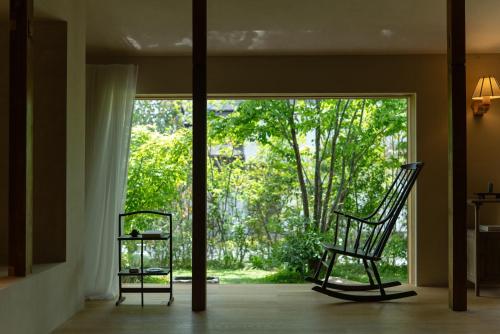 two chairs sitting in front of a sliding glass door at 蜜圡 Mitzdo in Tamano