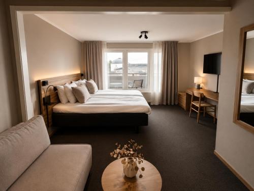 a hotel room with a bed and a couch at Pite Havsbad Piteå in Piteå