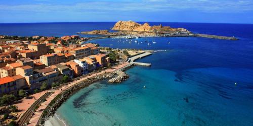 an aerial view of a city and the ocean at résidence Fogata in LʼÎle-Rousse