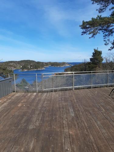 a deck with a view of the water at Havblikk, cozy cabin by the sea with beautiful views in Mandal