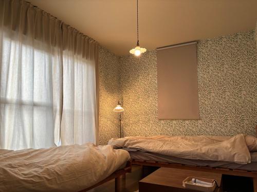 a bedroom with a bed and a window at Dar Sahha in Nara
