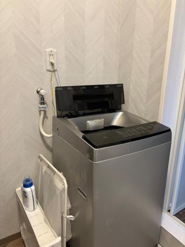 a washing machine in a room with a phone at Dar Sahha in Nara