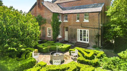 an aerial view of a house with a garden at West Kennett House in Marlborough