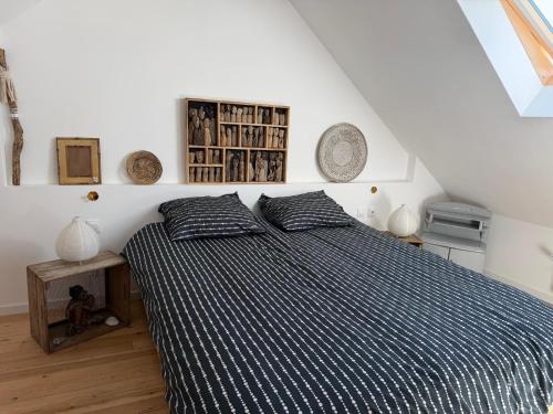 a bedroom with a bed with two pillows on it at Maison semi individuelle avec jardin in Ambleteuse