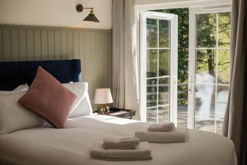 a bedroom with a bed with two towels on it at Blacksheep Cottage in Oban