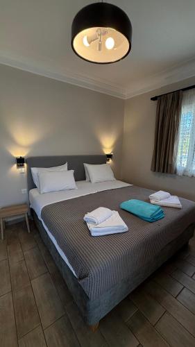 a bedroom with a large bed with towels on it at Le Torri Villas by Nidri holiday villas in Nydri