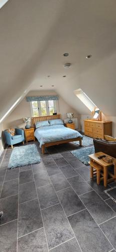 a bedroom with a bed and two rugs on the floor at The Hideaway in Tollard Royal