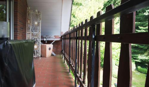 a porch of a house with a fence at Haus Theene in Südbrookmerland