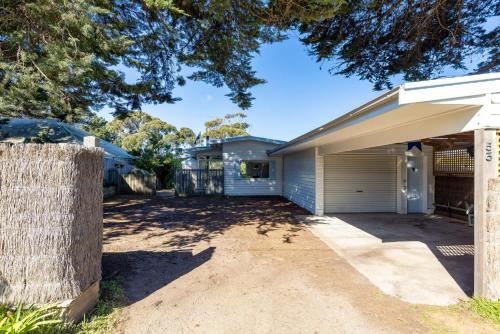 a house with a garage and a driveway at Parkview Cottage Portsea in Portsea