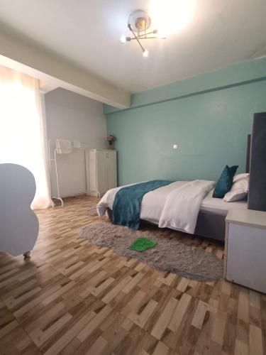 a bedroom with a bed and a wooden floor at The Cliff in Nairobi