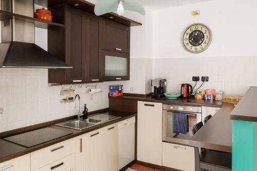 a kitchen with a sink and a stove top oven at B&B Casa Fortunata in Milan