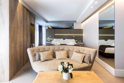 a living room with a couch and a bed at Hotel & Spa Ciudad de Binéfar in Binéfar