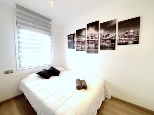 a bedroom with a bed and some pictures on the wall at Rhode 2a in Roses