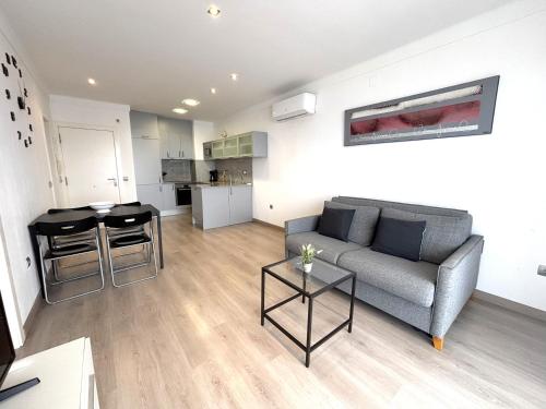 a living room with a couch and a table at Rhode 2a in Roses