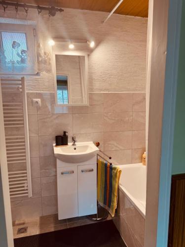 a bathroom with a sink and a bath tub at Apartmán Kristínka in Lendak