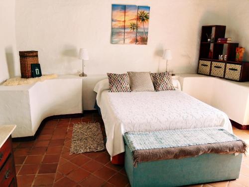 a bedroom with two beds and a couch at HelgaHome in Las Breñas