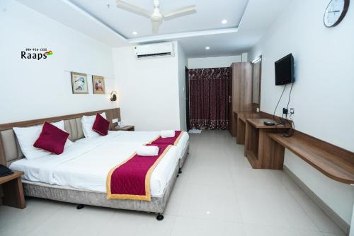 a bedroom with a bed and a television in it at Hotel SVM Grand Koti in Hyderabad