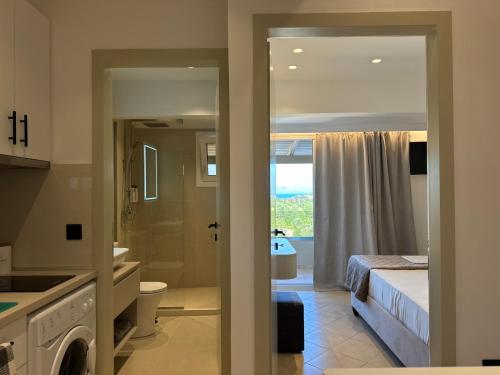 a bathroom with a toilet and a bed and a sink at Alex Apartment Suites in Virós